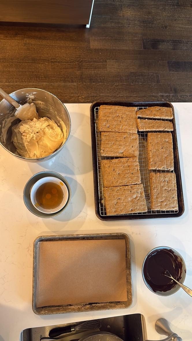 Peanut-butter buttercream, cooling banana layers, simple syrup, and dark ganache