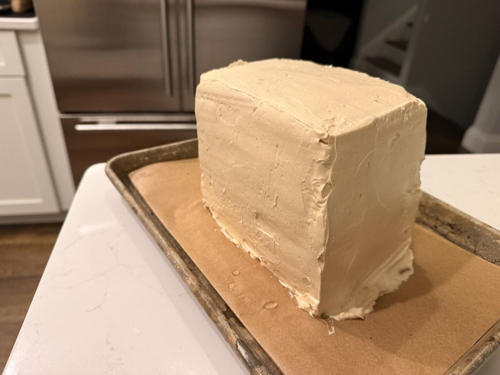 The stacked block coated smooth in peanut-butter buttercream