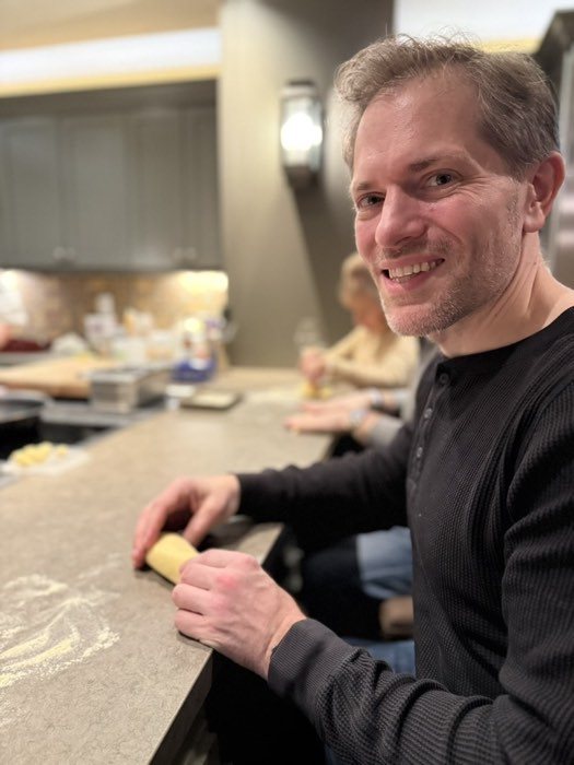 Michael rolling dough at the counter