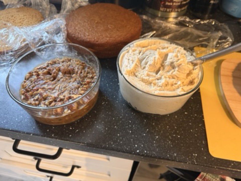 Bourbon pecan goo and brown butter cream cheese frosting ready to build