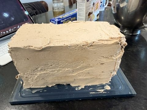 The frosted cake on the counter