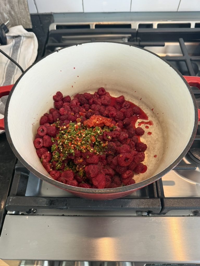 Raspberries and chopped peppers in the pot