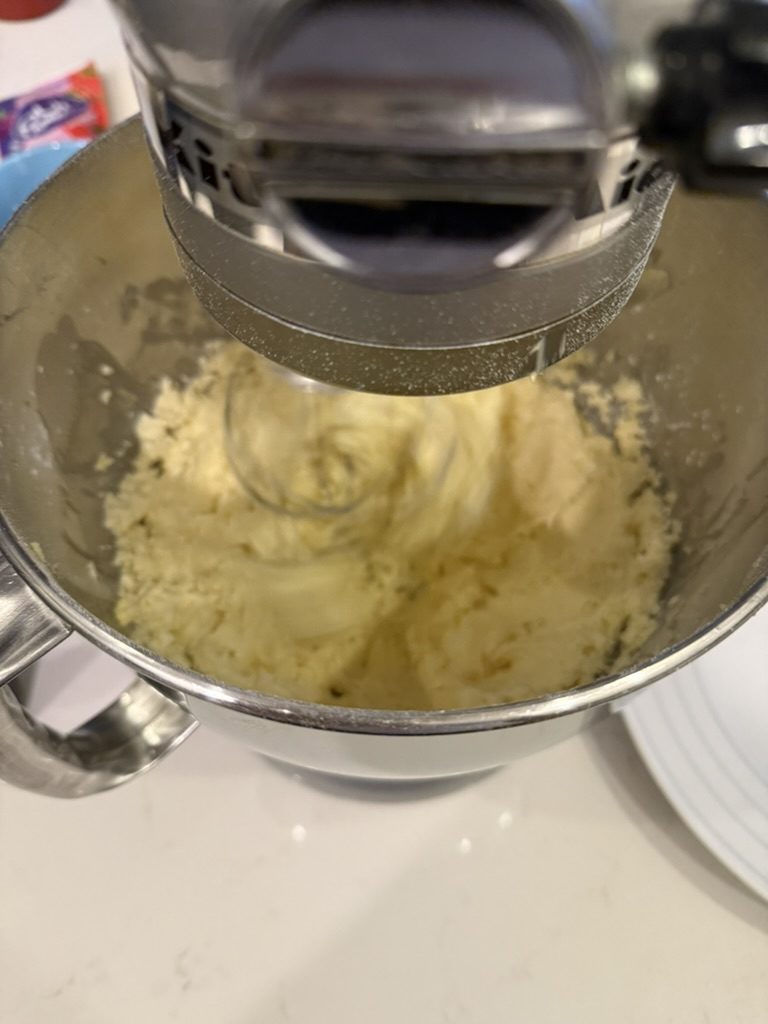 Strawberry buttercream coming together in the mixer